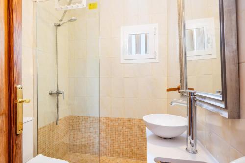 a bathroom with a shower with a toilet and a sink at Can Jordi in Cala Llombards