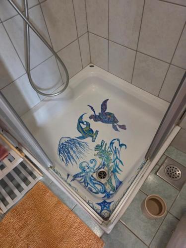a bath tub with a painting of animals on it at Babić Rituals apartments in Makarska