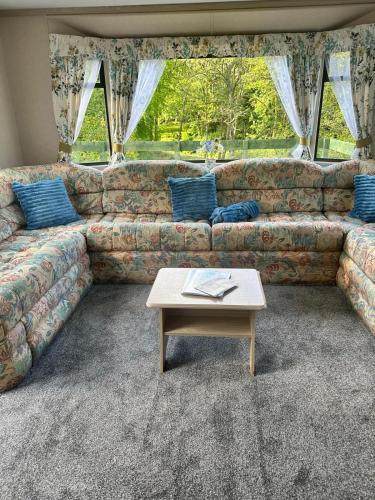 a living room with a couch and a coffee table at 48 River View in Dunoon