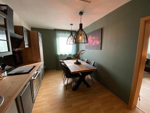 a kitchen with a table and a dining room at Ferienwohnung Sankt Michael in Bad Laasphe