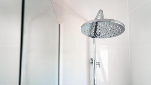 a shower head in a bathroom next to a door at Villa Marie in Benicarló