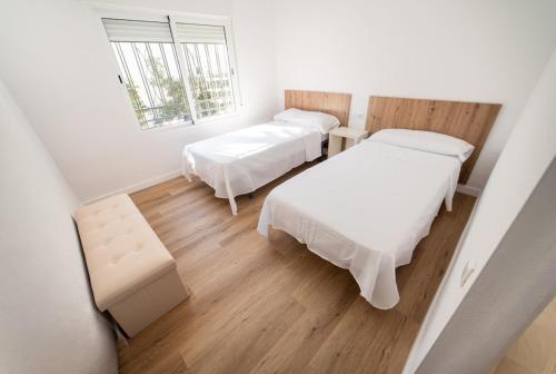 a room with two beds and a window at Villa Marie in Benicarló