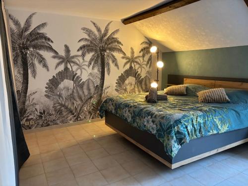 a bedroom with a bed with a mural of palm trees at La Maison du Bief in Écuisses