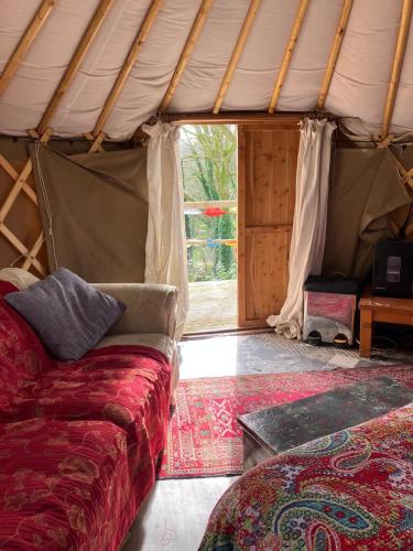 a living room with a couch in a tent at Fabulous Glamping Yurt in Bantry