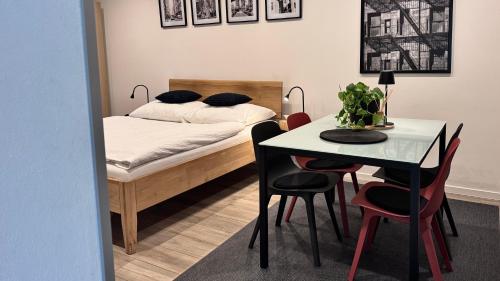a bedroom with a bed and a table with chairs at Apartmány Benešov in Benešov nad Ploučnicí