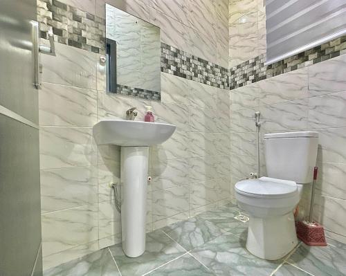 a bathroom with a sink and a toilet at Serene 5 Bedroom Duplex With Exclusive Compound in Iseri