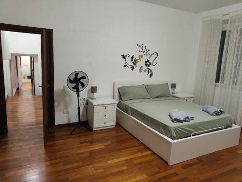 a bedroom with a bed and a dresser and a mirror at La Perla di Sulmona in Sulmona