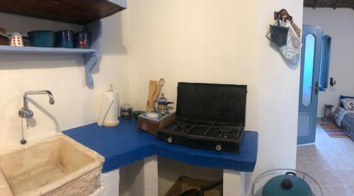 a bathroom with a sink and a suitcase on a counter at Antica Verdureria in Terme di Castel Doria