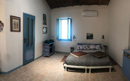 a bedroom with a bed and a window at Antica Verdureria in Terme di Castel Doria