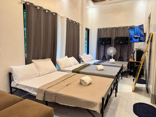 a room with two beds and a couch at Urban Canopy City Forest Staycation in Tigbawan