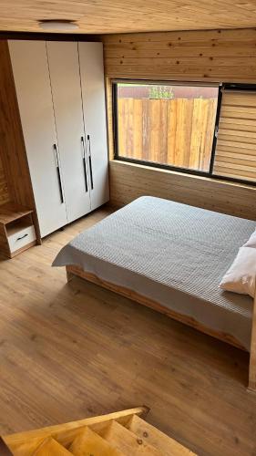 a bedroom with a bed and a window at Tau Saty in Saty