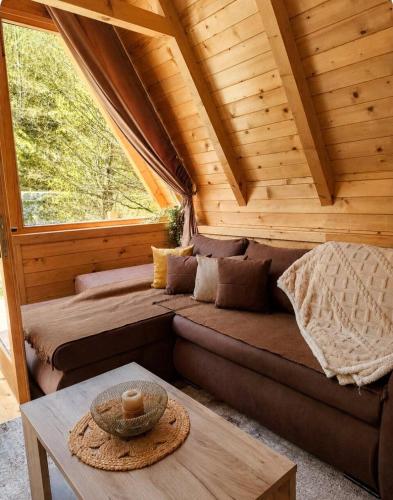 a room with a couch and a table in a cabin at Holiday Home Veruša in Podgorica