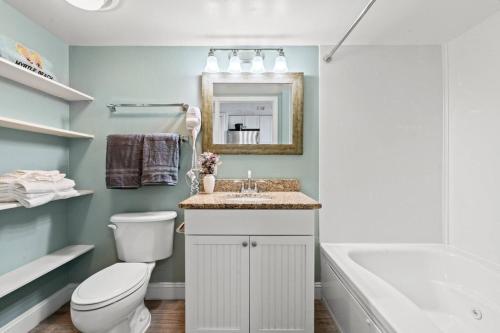 a bathroom with a toilet and a sink and a tub at Bay Watch Resort 1735 - Direct Oceanfront Balcony with Pools and Lazy River in Myrtle Beach