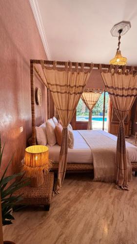 a bedroom with a bed with a canopy at Villa Amazonika By La Siredrah in Segraga