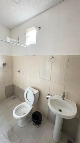 a bathroom with a toilet and a sink at Villa Marçal in São Mateus