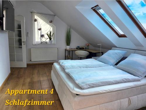 a bedroom with a large bed with blue pillows at SWINEMUENDE Ferienwohnung Speckmann in Świnoujście