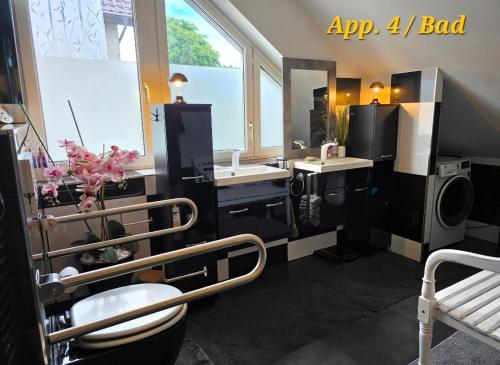 a bathroom with a sink and a toilet and a mirror at SWINEMUENDE Ferienwohnung Speckmann in Świnoujście