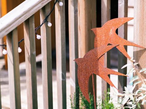 two star decorations hanging on a fence at The Challoners in Robertsbridge