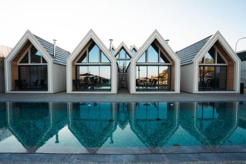 a house with a pool in front of it at NOE Suites in Ayios Theodhoros
