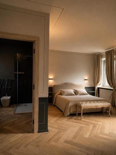 a bedroom with a large bed and a glass door at L'Orangerie del Castello in Morozzo
