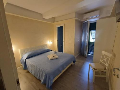 a bedroom with a bed with a towel on it at Suite Arcobaleno in Deiva Marina