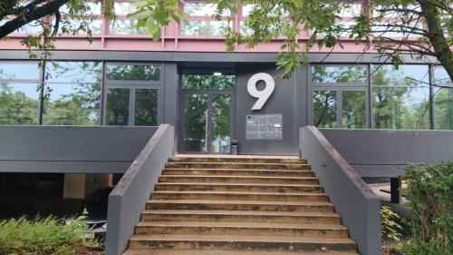 a staircase leading to a building with a number on it at Sitya Hostel München in Munich