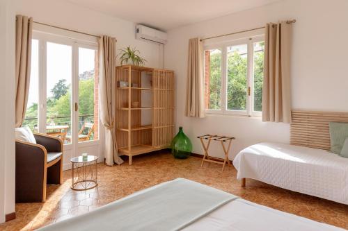 a bedroom with a bed and a couch and windows at Allegria in Baiardo