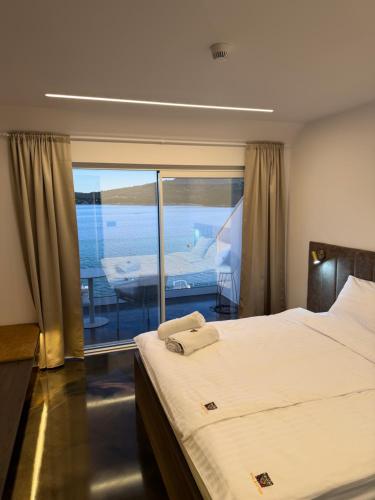 a bedroom with a bed and a view of the ocean at Hotel BOUTIQUE in Tisno