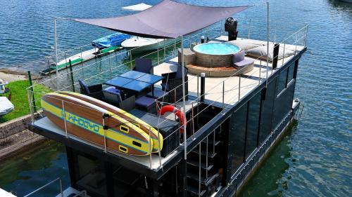 a small boat sitting on top of the water at DIAMOND Bigigio House Boat in Lisanza