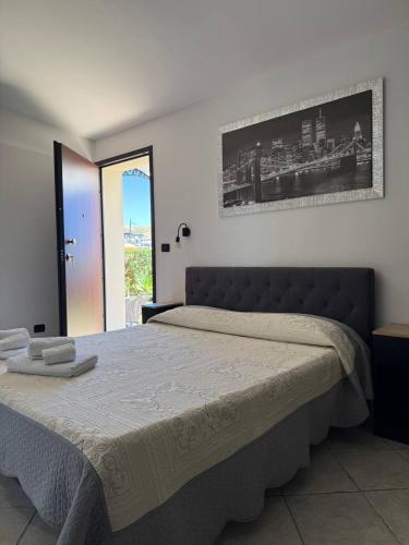 a bedroom with a bed with a picture on the wall at Bed & Breakfast La Villetta in Botricello