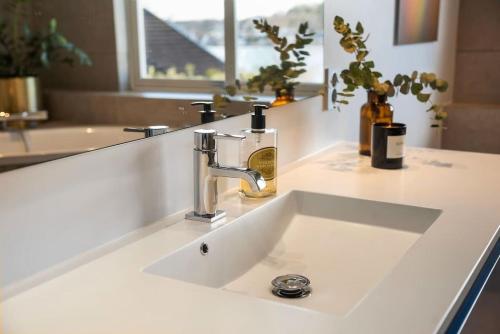 a bathroom sink with a faucet on a counter at Seaside House 5 BR in Garder