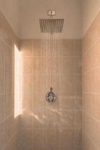 a shower with a shower head in a bathroom at Capo Vaticano Suites in Capo Vaticano