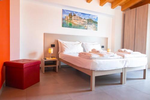 a bedroom with a bed with two people laying on it at Corte Rocchetti Suite in Lazise