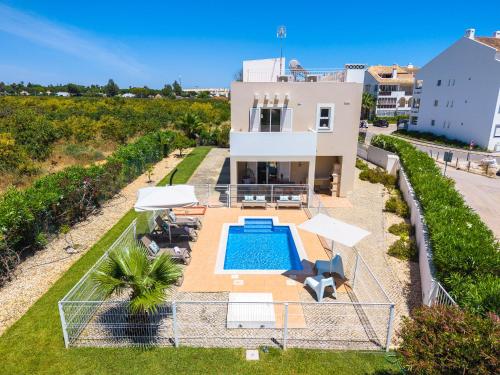an aerial view of a villa with a swimming pool at Roots Villa - Casa das Árvores in Cabanas de Tavira