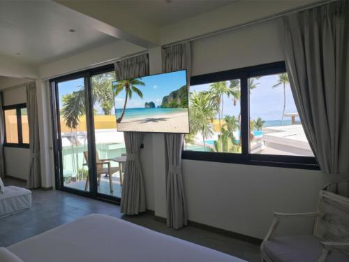 a bedroom with a view of the ocean at Casa By The Sea in Bangrak Beach