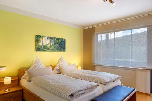 a bedroom with two beds and a window at Lina's Rhön in Bad Brückenau
