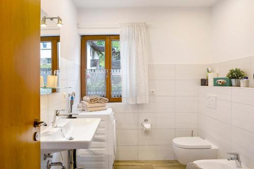 a white bathroom with a sink and a toilet at Lina's Rhön in Bad Brückenau