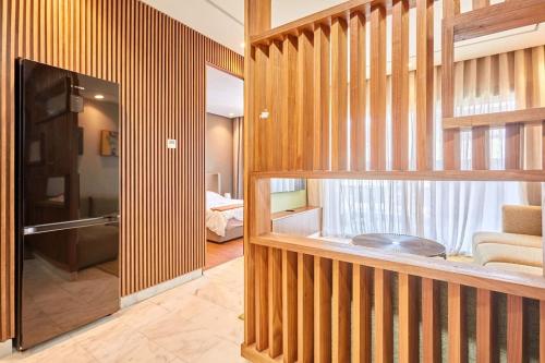a living room with wood paneled walls and a television at Stunning Studio Pool View CFC Casablanca in Casablanca