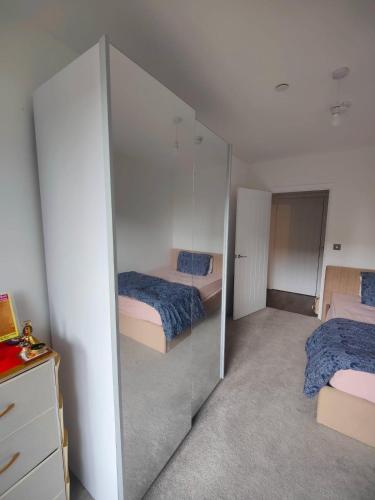 a mirror in a bedroom with two beds in it at sPARSH in London