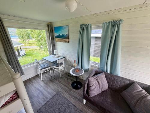 a living room with a couch and a table at Mørsvikbotn Camping AS in Mørsvik