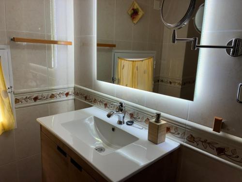 a bathroom with a sink and a mirror at Casa Rural Senderismo in Lumbreras