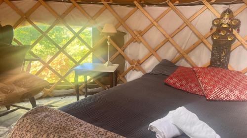 a bedroom with a bed in a yurt at Adorable Yurt Glamping Bantry in Bantry