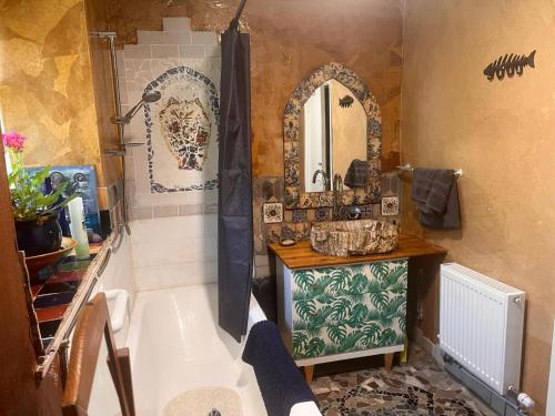 a bathroom with a tub and a sink and a mirror at Adorable Yurt Glamping Bantry in Bantry