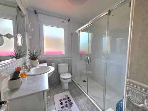a bathroom with a shower and a toilet and a sink at Apartamento Ora al Mare - 32002 in Pedreña