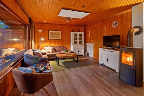 a living room with a couch and a table at Ortheide 68 in Böddenstedt