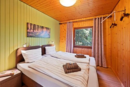 a bedroom with a bed with a purse on it at Ortheide 68 in Böddenstedt