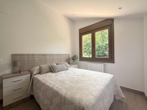 a bedroom with a bed and a window at La Villa de Miera - 12809 in Ajo