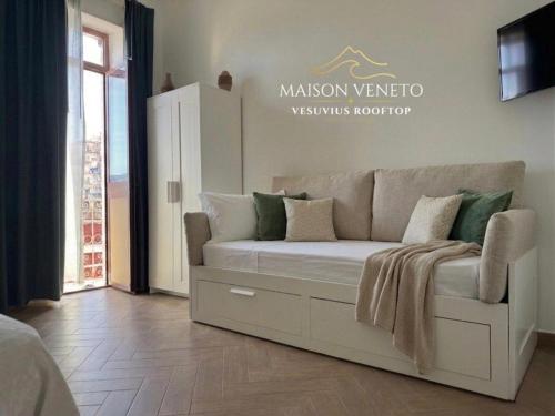 a living room with a couch in a room at Maison Veneto Vesuvius Rooftop in Torre Annunziata