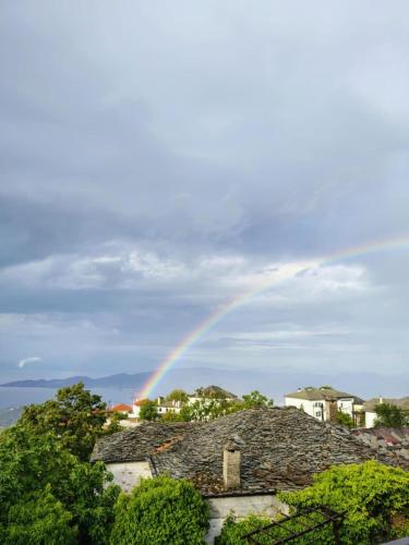 a rainbow in the sky over a house at Pelion country house in Volos
