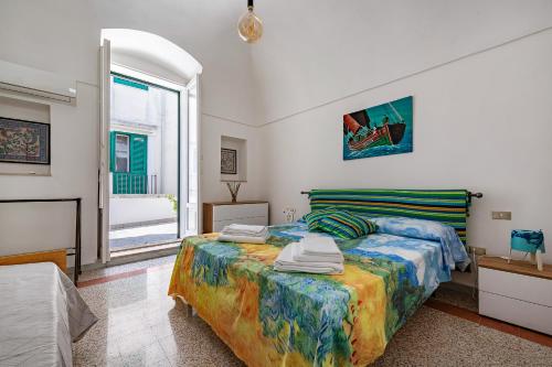 a bedroom with a bed and a window at 15min Polignano Puglia Historical Center Terrace in Conversano